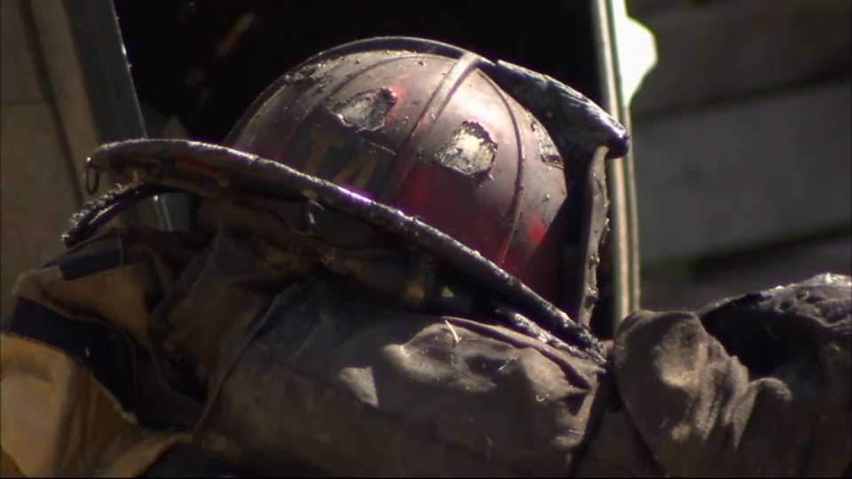 Footage shows firefighter fall through burning roof