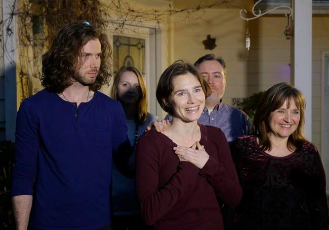 Amanda Knox, center, stands with her mother, Edda Mellas, right, and her fiance, Colin Sutherland, left.