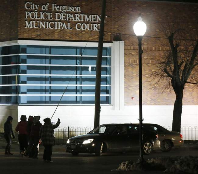 In this March 4, 2015 file photo, protesters block traffic on the street outside the Ferguson, Mo., police department in Ferguson. 