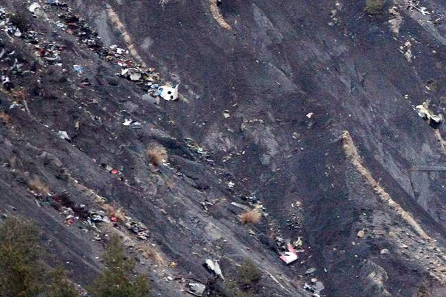 Debris of the Germanwings passenger jet is scattered on the mountain side near Seyne les Alpes, French Alps, Tuesday, March 24, 2015.