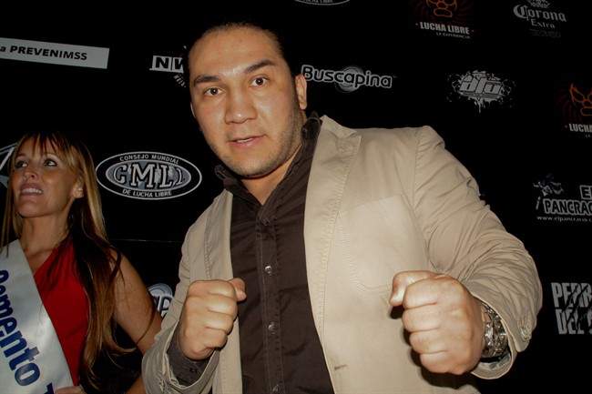 In this May 27, 2010 photo, Mexican wrestler Pedro Aguayo Ramirez, known as Hijo del Perro Aguayo, poses for photographers at the start of a news conference in Mexico City. Ramirez, the son of a wrestling legend in the country, died early Saturday, Mar. 21, 2015, from a hit suffered in the ring in Tijuana.