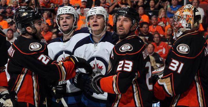 Drew Stafford and Mark Scheifele of the Winnipeg Jets make their points to the referee with Kyle Palmieri and Francois Beauchemin and goalie Frederik Andersen of the Anaheim Ducks looking on during the second period in Game One of the Western Conference Quarterfinals during the 2015 NHL Stanley Cup Playoffs.