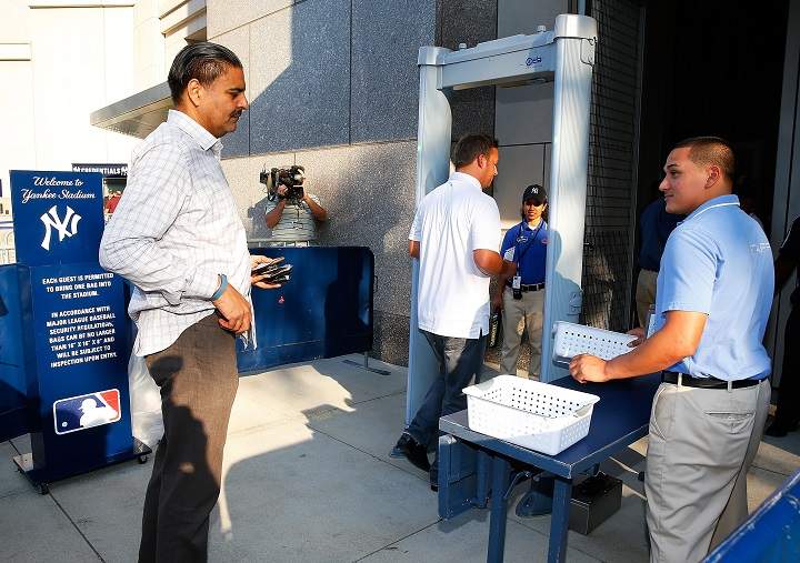Fans walk through a newly installed metal detector at Gate 2 prior to the game between the New York Yankees and the Houston Astros at Yankee Stadium on August 19, 2014 in the Bronx borough of New York City. 