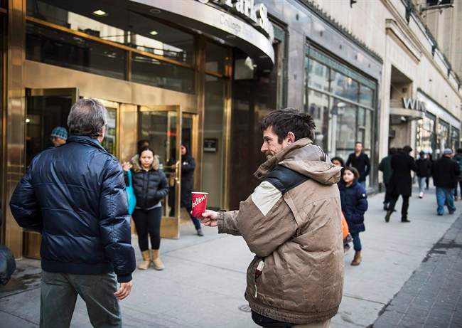 Toronto-born Joe Sallai, 45, panhandles on the corner of College and Yonge in Toronto on Friday, March 20 2015. Statistics Canada does not track murders, assaults and sexual assaults committed against homeless people. But people who live on the street and their advocates say they happen frequently.