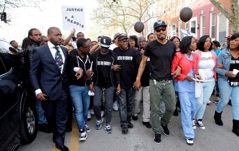 Supporters and family members of Freddie Gray lead a march to the Baltimore Police Department’s Western District police station during a vigil for Freddie Gray, Tuesday, April 21, 2015, in Baltimore. Gray died from spinal injuries a week after he was arrested and transported in a police van.