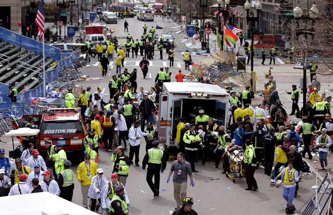 In this April 15, 2013, file photo, medical workers aid injured people following an explosion at the finish line of the 2013 Boston Marathon in Boston.