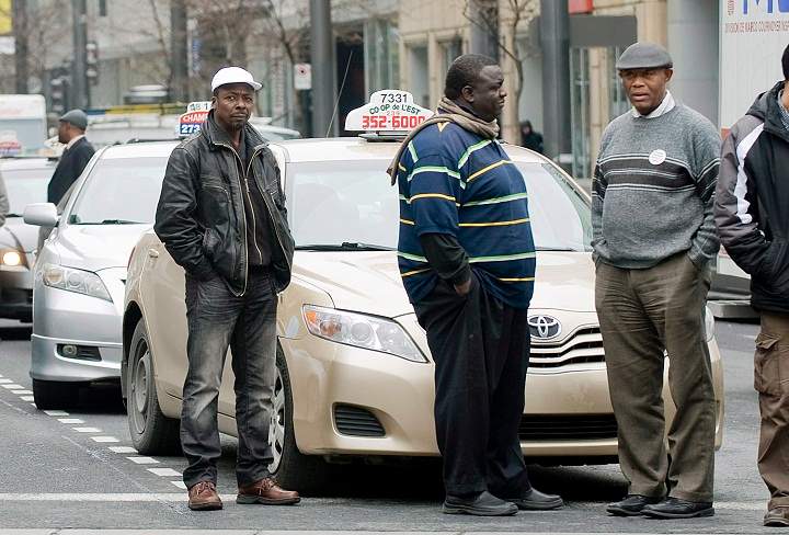 Taxi drivers block a street outside the Montreal courthouse, Wednesday, May 2, 2012, to show their support for Guercy Edmond who is in custody on charges of aggravated assault, assault with a weapon, hit-and-run and dangerous driving.