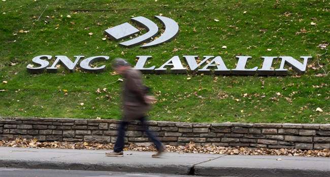 A man walks past the headquarters of SNC-Lavalin in Montreal on November 6, 2014.