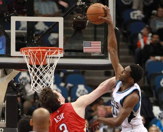 Minnesota Timberwolves’ Andrew Wiggins (22) dunks on New Orleans Pelicans’ Omer Asik in the half of an NBA basketball game Monday, April 13, 2015, in Minneapolis.