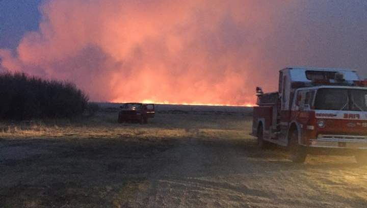 Six fire departments battle through the night to bring a grass fire near Borden, Sask. under control.