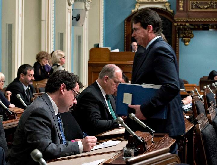 Parti Quebecois leadership candidate and Opposition MNA Pierre Karl Peladeau walks by co-candidate Bernard Drainville before question period Wednesday, April 22, 2015 at the legislature in Quebec City.