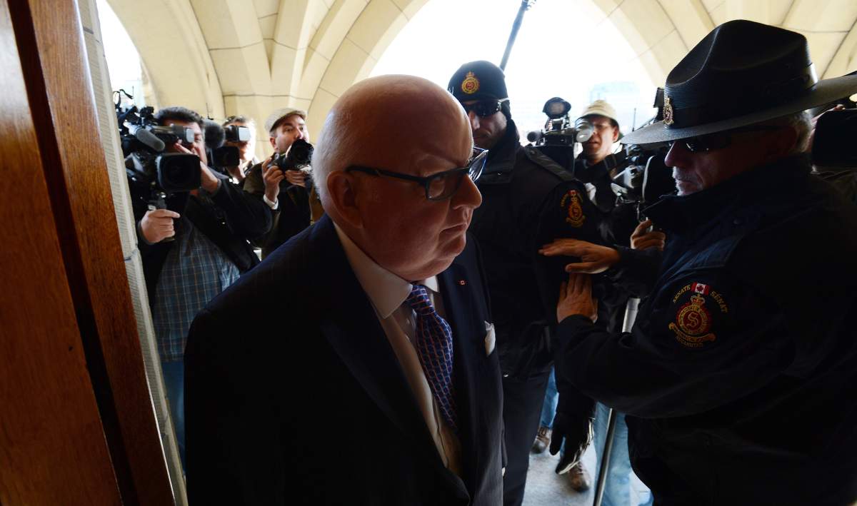 Sen. Mike Duffy arrives at the Senate on Parliament Hill in Ottawa on Tuesday, October 22, 2013. THE CANADIAN PRESS/Sean Kilpatrick