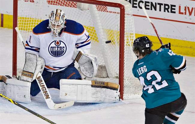 San Jose Sharks Bryan Lerg (42) scores a goal on Edmonton Oilers goalie Laurent Brossoit (1) during third period NHL hockey action in Edmonton, Alta., on Thursday April 9, 2015. 
