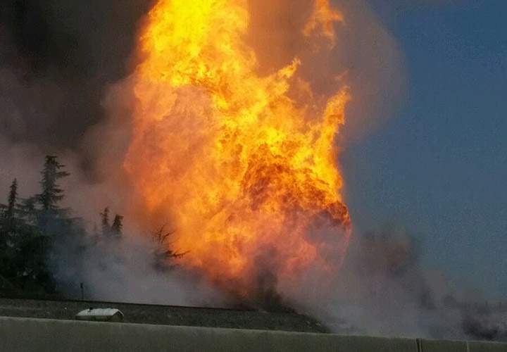 A fireball erupts after a large gas pipeline exploded in Fresno, Calif., Friday, April 17, 2015. The explosion and fire closed both directions of Highway 99, authorities said.