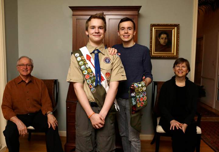 In this file photo, Boy Scout Pascal Tessier, now 18, center left, and his brother Lucien pose for a portrait with their parents,.