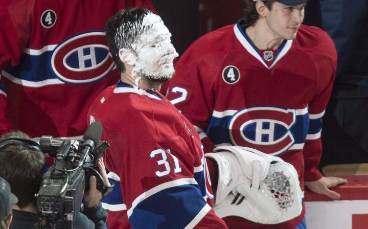 Montreal Canadiens goalie Carey Price look over after being pied following their 4-3 victory over the Detroit Red Wings during overtime in NHL hockey action Thursday, April 9, 2015 in Montreal. Price broke a team record with 43 wins for a goaltender.