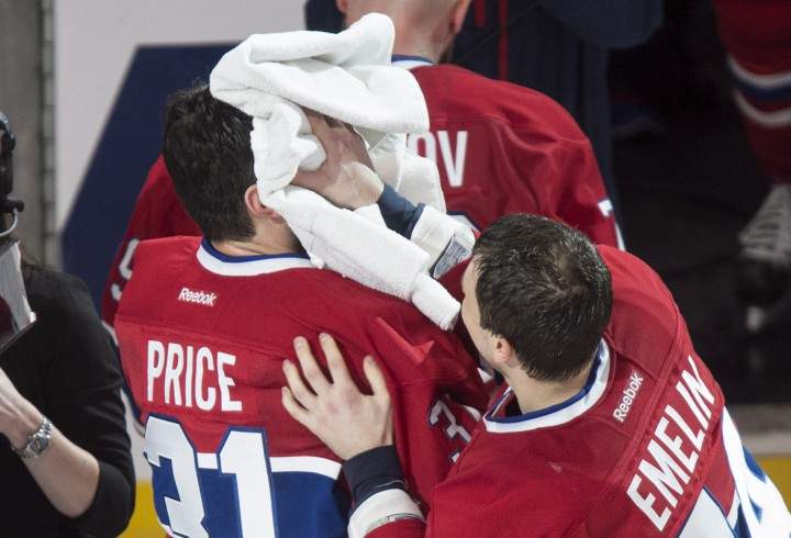 Montreal Canadiens goalie Carey Price gets pied by teammate Alexei Emelin following their 4-3 victory over the Detroit Red Wings during overtime in NHL hockey action Thursday, April 9, 2015 in Montreal. Price broke a team record with 43 wins for a goaltender.