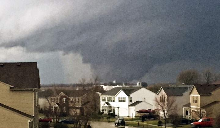 In this photo provided by Emily Mains, a tornado is viewed near Pearl Street from a home in the Kennedy’s subdivision in Kirkland, Ill., on Thursday, April 9, 2015.