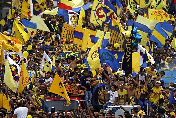 America’s fans wave the club’s flags upon their arrival to the Azteca stadium to watch the season’s final soccer match of the Mexican league against Cruz Azul in Mexico City, Mexico, Sunday, May 26, 2013.