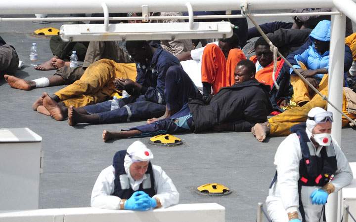 Survivors of the smuggler’s boat that overturned off the coasts of Libya lie on the deck of the Italian Coast Guard ship Bruno Gregoretti, in Valletta’s Grand Harbour, Monday, April 20 2015.