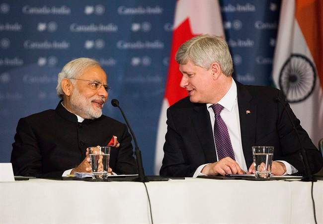 Canadian Prime Minister Stephen Harper, right, participates in a business roundtable with India's Prime Minister Narendra Modi, left, in Toronto on Thursday, April 16, 2015. THE CANADIAN PRESS/Michelle Siu.