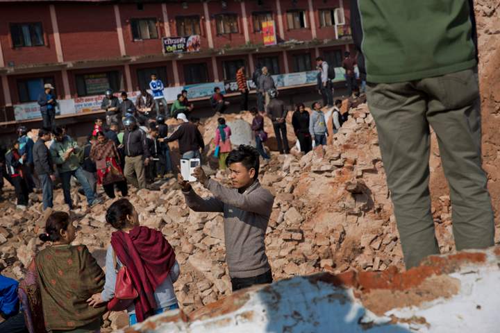 A man takes a selfie at the historic Dharahara Tower, a city landmark, that was damaged in Saturday’s earthquake in Kathmandu, Nepal, Monday, April 27, 2015.