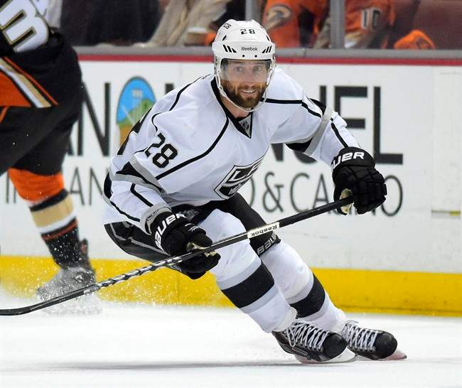 FILE - Los Angeles Kings center Jarret Stoll skates with the puck during the first period in Game 2 of an NHL hockey second-round Stanley Cup playoff series Anaheim Ducks, in this May 5, 2014 file photo taken in Anaheim, Calif. Stoll has signed with the New York Rangers after pleading guilty to two reduced charges in felony cocaine case.