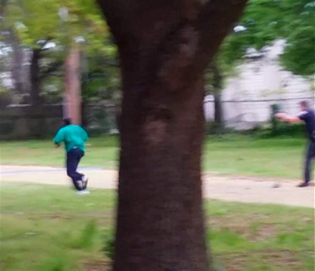 In this April 4, 2015, frame from video provided by Attorney L. Chris Stewart representing the family of Walter Lamer Scott, Scott appears to be running away from City Patrolman Michael Thomas Slager, right, in North Charleston, S.C.