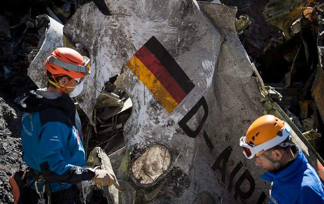 In this photo taken on Tuesday, March 31, 2015 and provided by the French Interior Ministry, French emergency rescue services work among debris of the Germanwings passenger jet at the crash site near Seyne-les-Alpes, France.