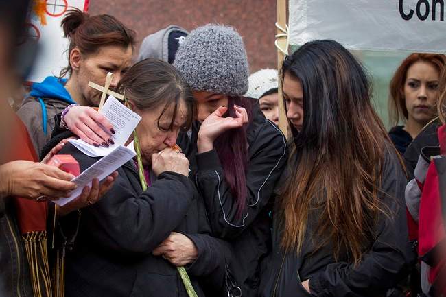 Family members embrace one another as protesters rally outside Edmonton’s City Hall on Thursday, April 2, 2015 in support of Cindy Gladue