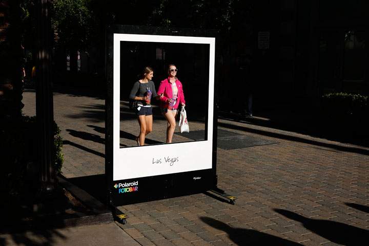 In this April 15, 2015, photo, people walk by the Polaroid Fotobar store at the Linq in Las Vegas. Whether you're coming to Las Vegas for a convention, wedding or just a vacation, casinos are just one option, along with shopping, spas, food, nightlife, festivals and various other adventures.