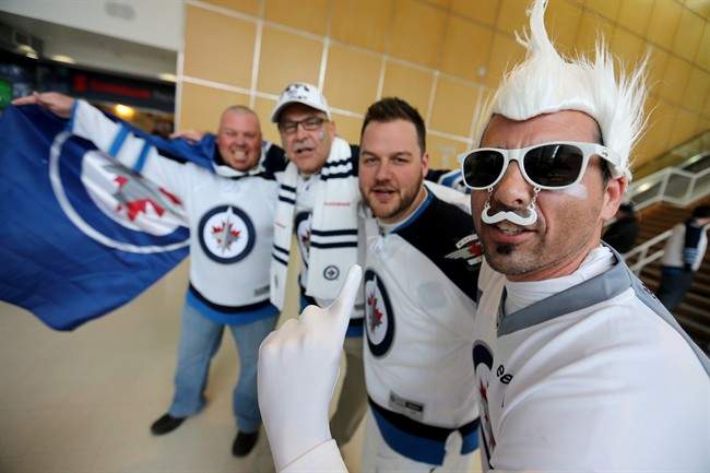 Winnipeg Jets\’ fans, from left, Yves Lapointe, Guy Chateau, Russ Lapointe, and Marc Chateau cheering for their team prior to game three NHL playoff hockey against the Anaheim Ducks action in Winnipeg, Monday, April 20, 2015. n