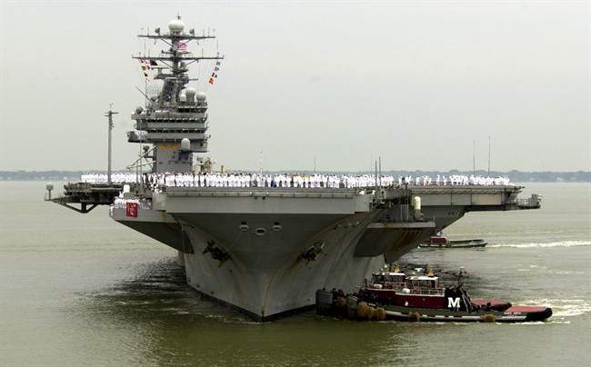 U.S. defence officials say U.S. Navy ships will begin accompanying U.S.-flagged commercial ships when they transit the Strait of Hormuz.