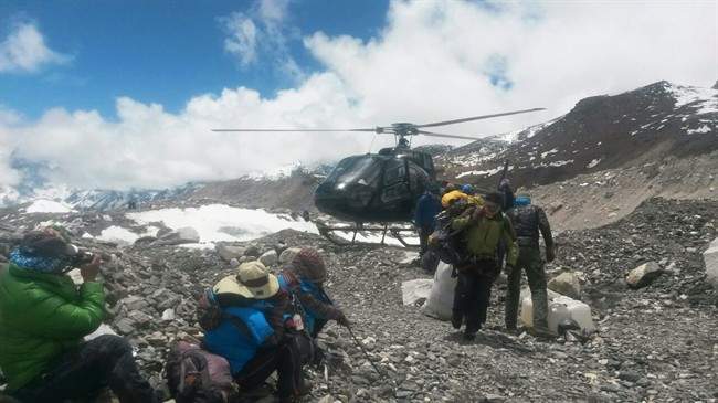 A rescue chopper lands carrying people from higher camps to Everest Base Camp, Nepal, Monday, April 27, 2015. An avalanche on Saturday, set off by the massive earthquake that struck Nepal, left more than a dozen people dead and dozens more injured.