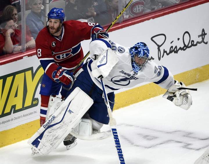 Montreal Canadiens winger Brandon Prust (8) runs into Tampa Bay Lightning goalie Ben Bishop (30) during third period of Game 2 NHL second round playoff hockey action Sunday, May 3, 2015 in Montreal.