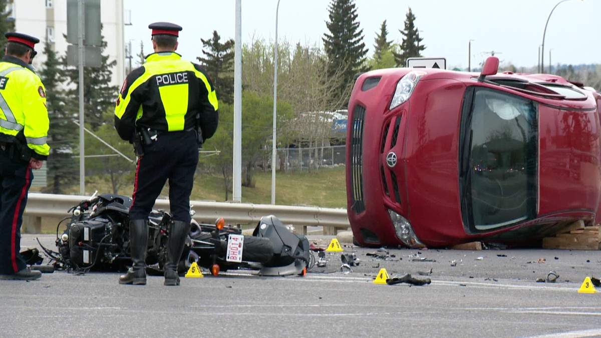 Police investigate a collision between a motorcycle and a car along Charleswood Drive N.W. on Thursday, May 7, 2015.