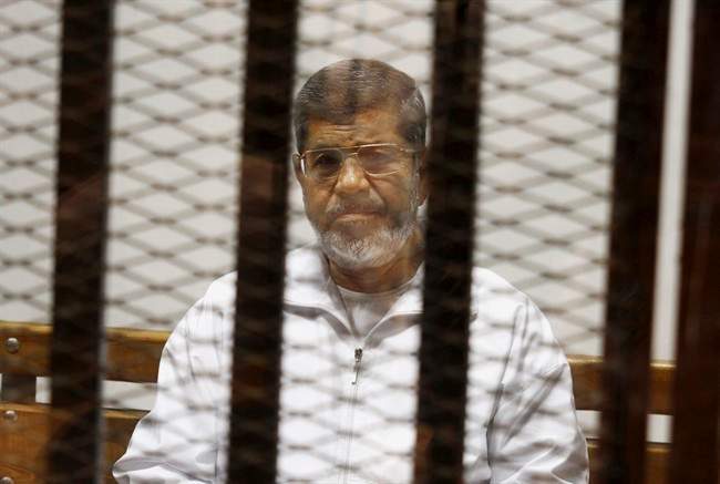 Egypt’s ousted Islamist President Mohamed Morsi sits in a defendant cage in the Police Academy courthouse in Cairo, Egypt, May 8, 2014.
