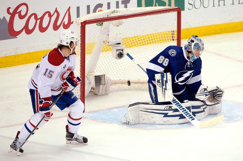 Montreal Canadiens right wing P.A. Parenteau, left, watches as a shot by defenseman Jeff Petry gets past Tampa Bay Lightning goalie Andrei Vasilevskiy,right, of Russia, during the second period of Game 4 of a second-round NHL Stanley Cup hockey playoff series in Tampa, Fla., Thursday, May 7, 2015.