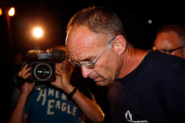 Douglas Garland is escorted into a Calgary police station in connection with the disappearance of Nathan O'Brien and his grandparents in Calgary, Alta., on July 14, 2014.