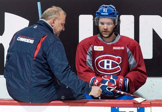 Montreal Canadiens head coach Michel Therrien, left, gives a few pointers to David Desharnais during a practice Monday, April 13, 2015.