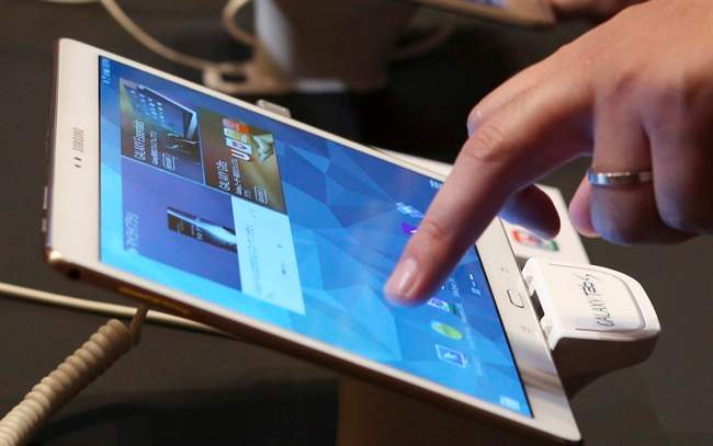 A visitor tries out a Samsung tablet during an event in Tokyo, July 31, 2014.