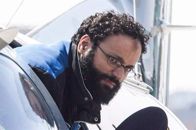 Chiheb Esseghaier, one of two men accused of plotting a terror attack on rail target, is led off a plane by an RCMP officer at Buttonville Airport just north of Toronto on April 23, 2013.