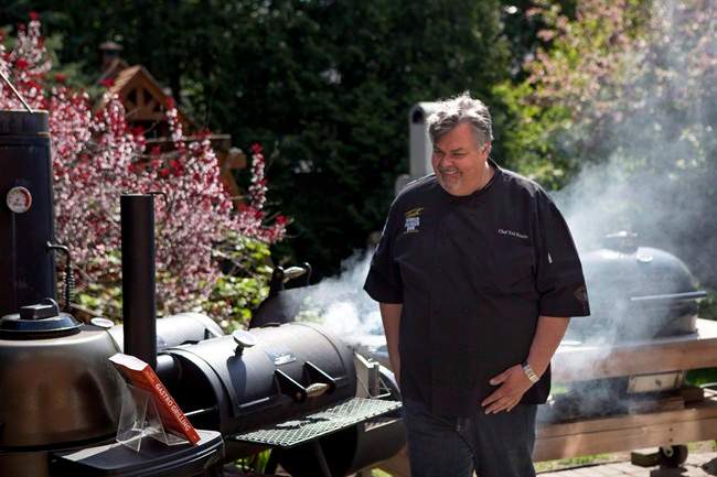 Ted Reader, author of the recent book "Gastro Grilling" fires up a charcoal grill in Toronto on Wednesday May 15, 2013.