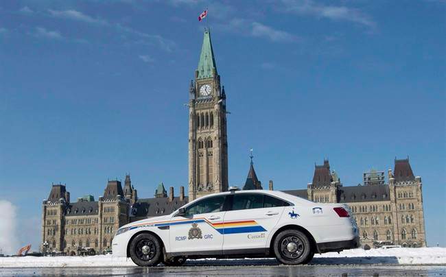 An RCMP police car sits outside the Parliament buildings on Parliament Hill in Ottawa on February 6, 2015. 