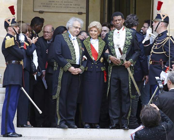 Haitian-born Canadian writer Dany Laferriere, right, poses with Academicians Helene Carrere d'Encausse, center, and Amin Maalouf, left, after his induction ceremony at the Academie Francaise in Paris, Thursday May 28, 2015.