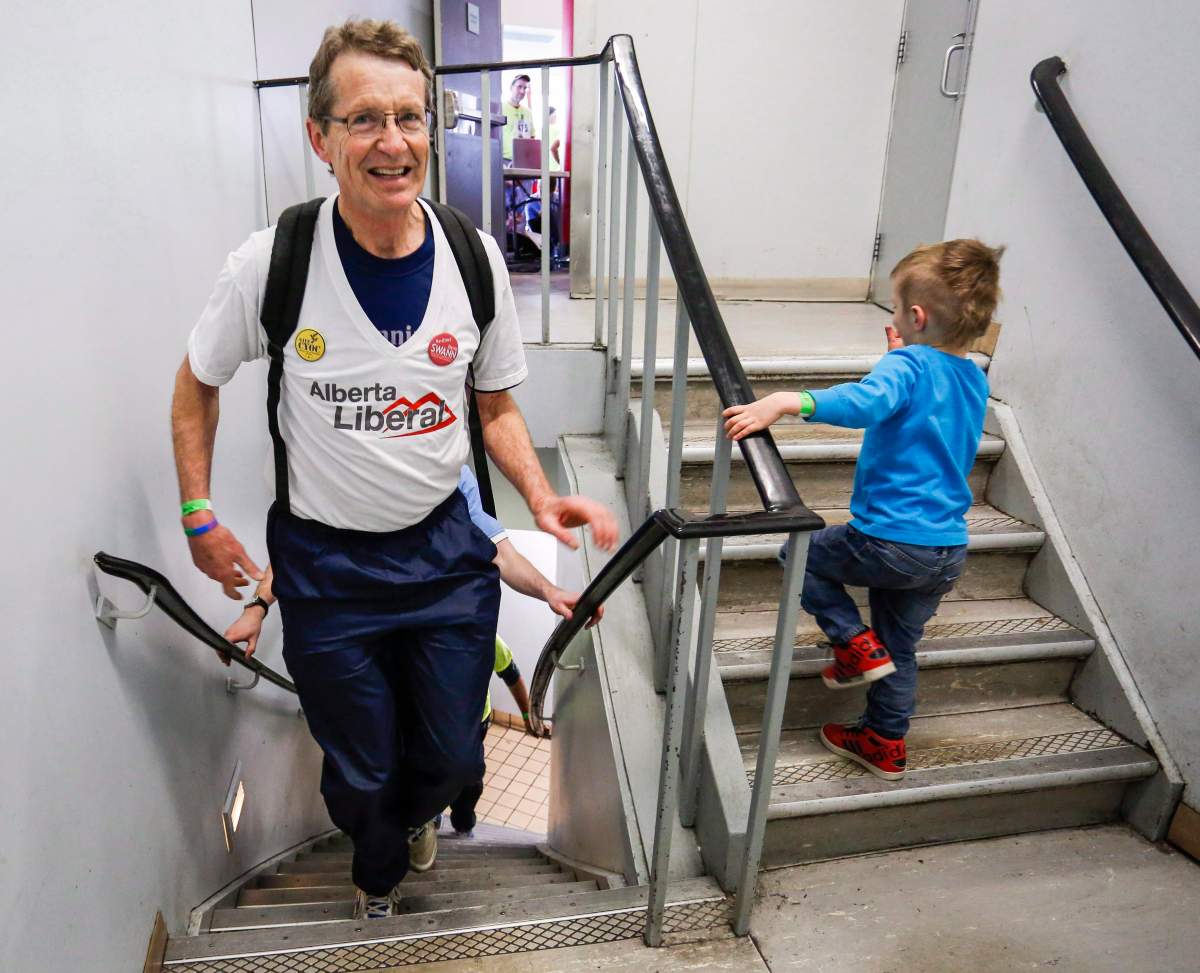 Alberta Liberal leader David Swann, left, follows his grandson Kiel Archuleta, four, as he climbs the Calgary Tower in the Alberta Wilderness Association’s Climb and Run for Wilderness in Calgary, Saturday, April 18, 2015.