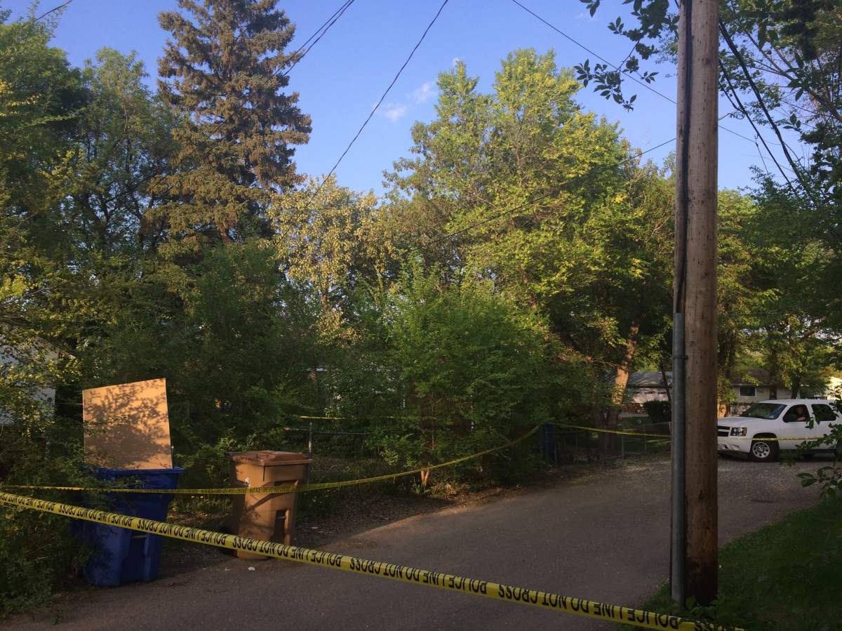 Police tape cordoned off the back alley behind house number 15 on Ingersoll Crescent.