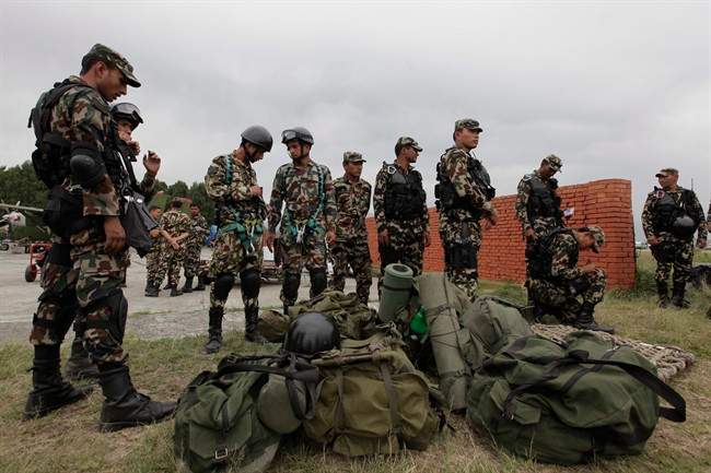 Nepalese army soldiers prepare to leave for a rescue mission to the site where the suspected wreckage of a U.S. Marine helicopter, that disappeared earlier this week while on a relief mission in the earthquake-hit Himalayan nation was spotted.