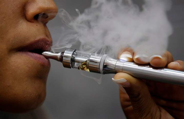 A woman smokes an electronic cigarette in Paris, Oct. 8, 2013. 