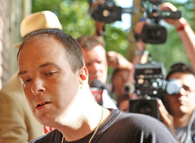 In this May 11, 2015 file photo, Matthew Apperson, who authorities say was involved in a shooting incident involving George Zimmerman, enters the Lake Mary Police Department with his attorney in Lake Mary, Fla. 